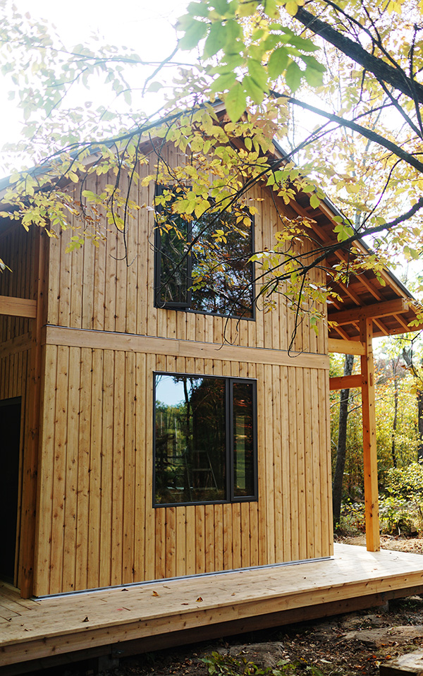 The east gable, cedar boards and the deep window reveals