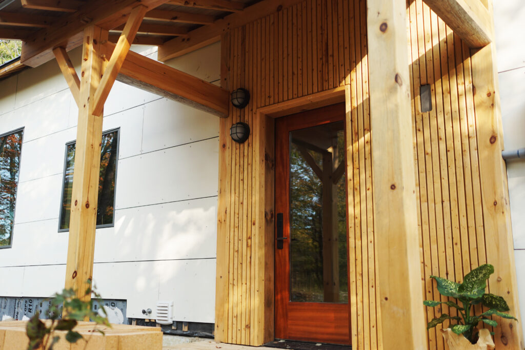 Entry porch: timber posts and braces carrying the roof over the door