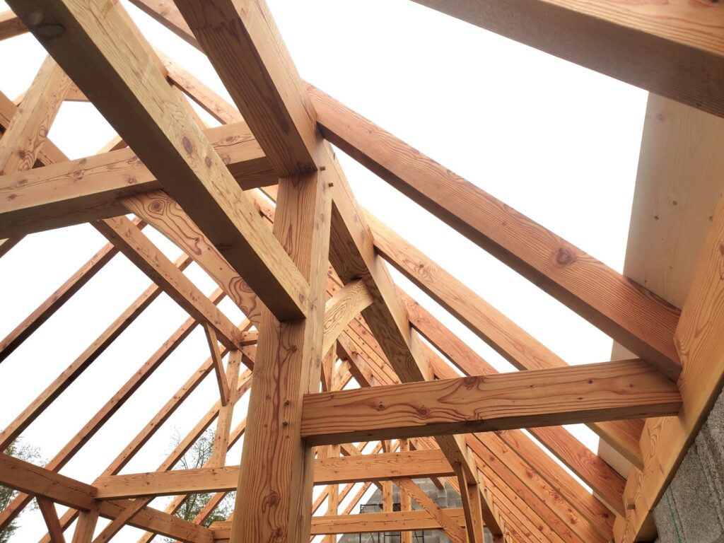 Inside the meditation hall frame looking up into the fifty degree gable